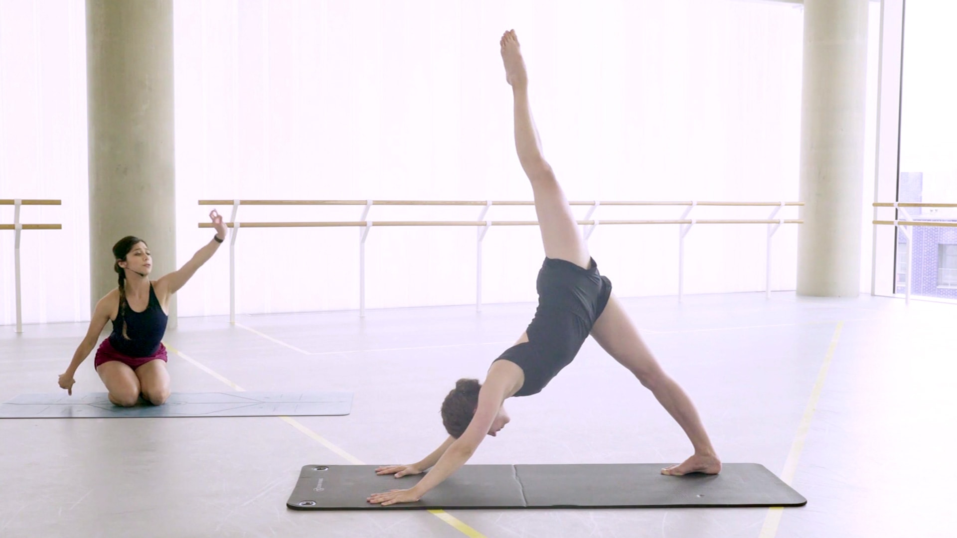Yoga with Crystal Costa demonstrated by Emilia Cadorin: downward dog adapted with extended leg
